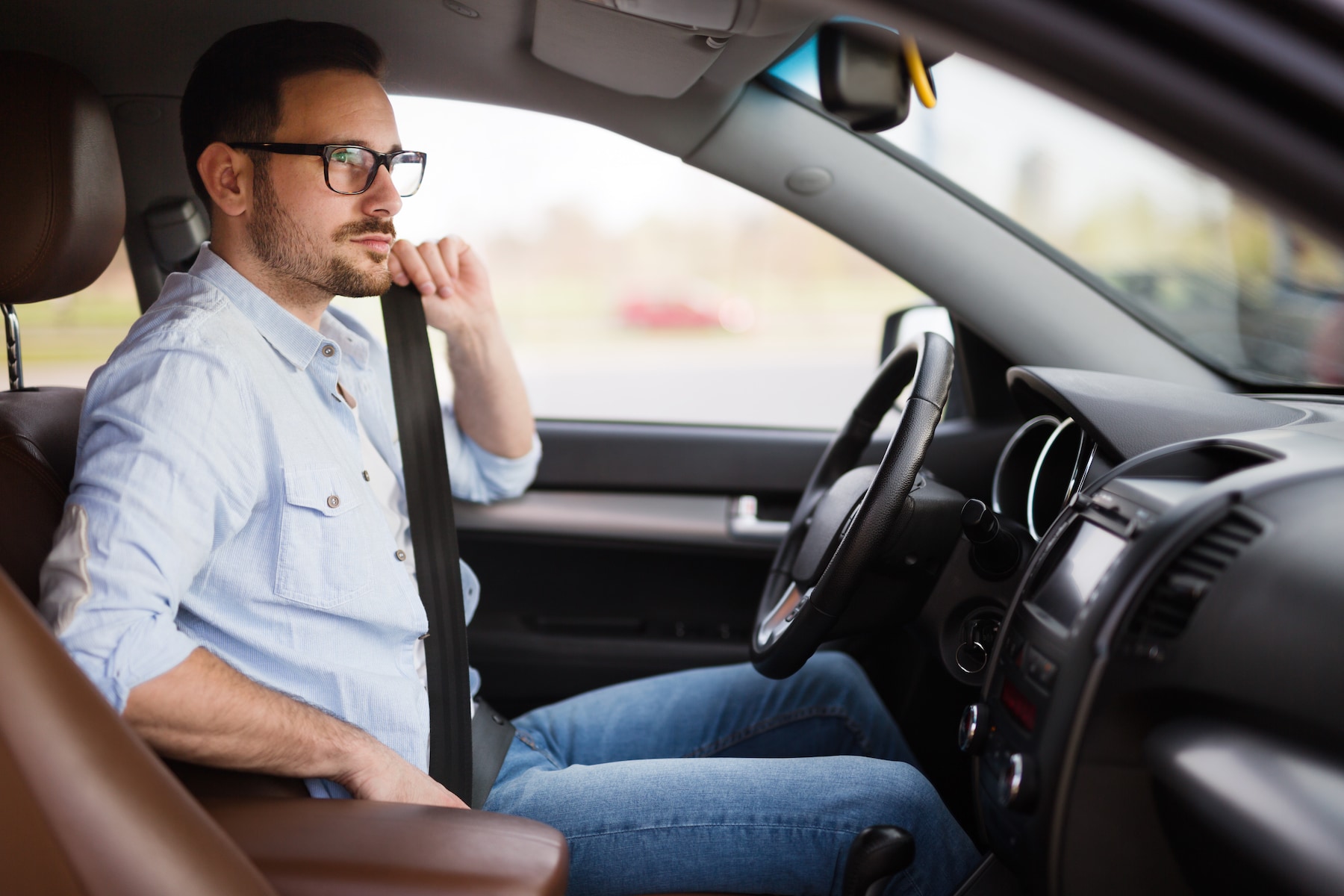 when to trade in your vehicle at Volvo Cars of New Bern in New Bern | Man adjusting seat belt