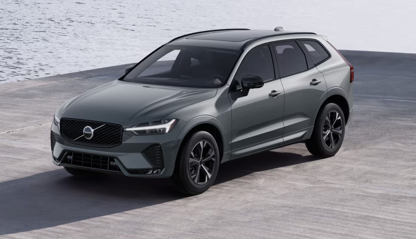 Gray Volvo XC60 parked on a concrete surface near the water.