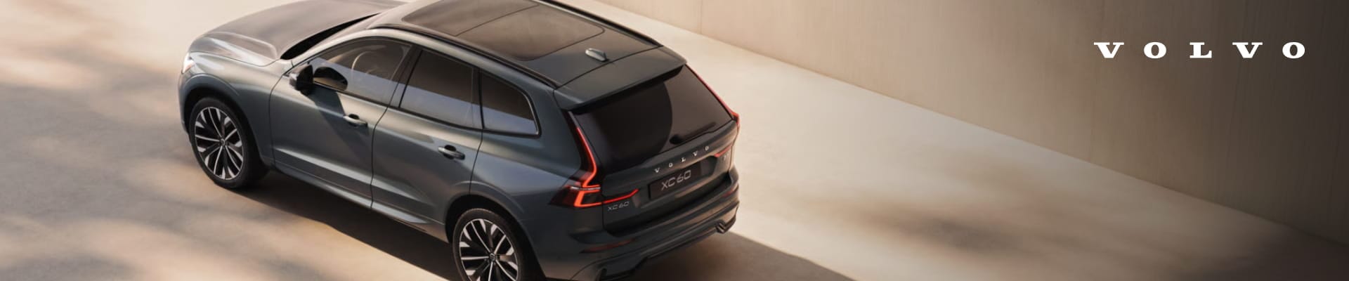 Gray Volvo XC60 viewed from above in a modern architectural setting.