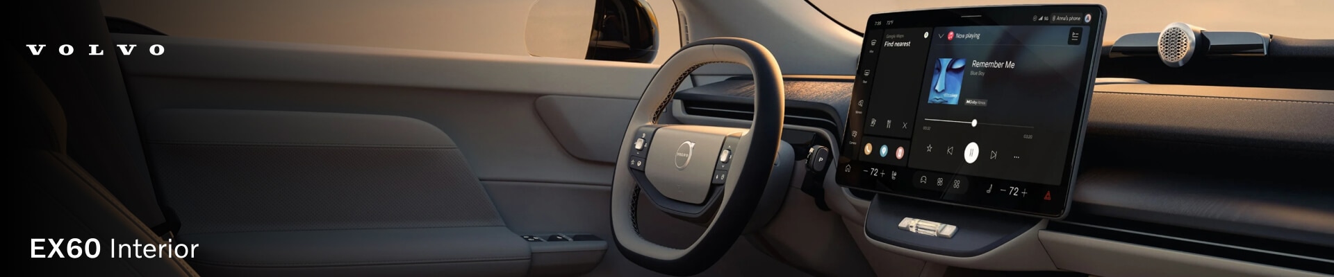 Driver-side view of a light beige Volvo EX60 dashboard and center touchscreen.