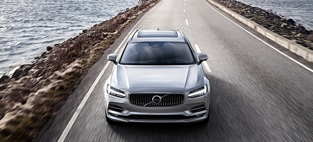 Volvo S90 with Polestar Optimization Volvo S90 driving along the water