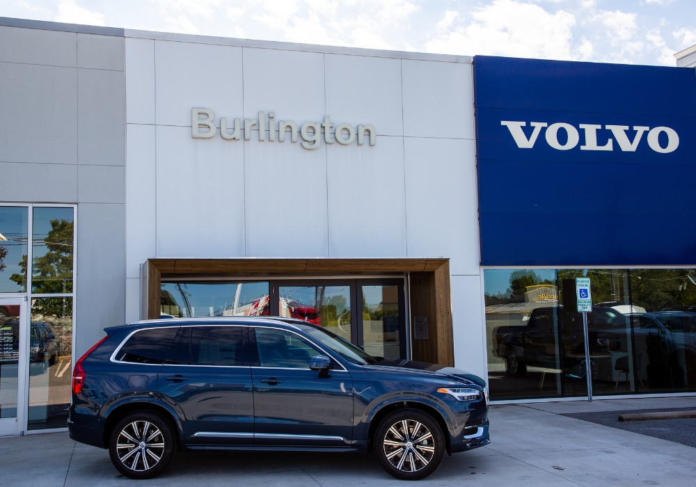 Volvo SUV parked directly in front of a Volvo dealership located in Burlington, NC