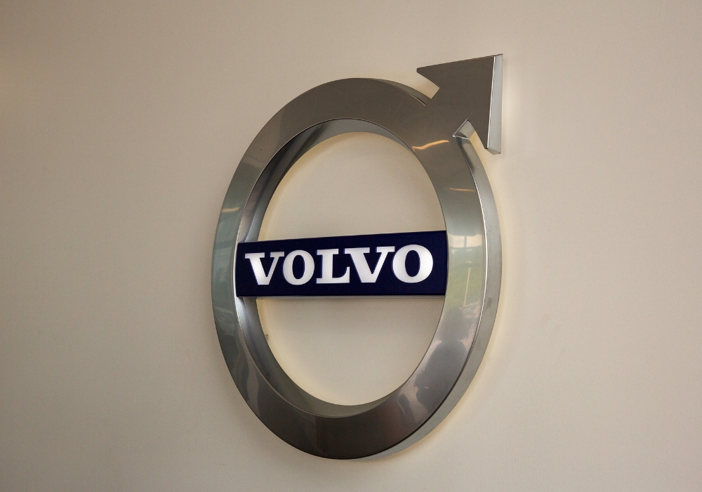 The Volvo logo affixed to a beige colored wall inside the Volvo Cars Burlington