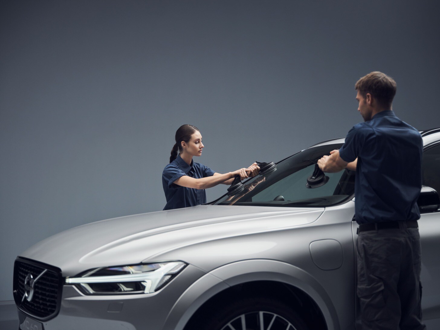 Volvo technicians repairing a windscreen