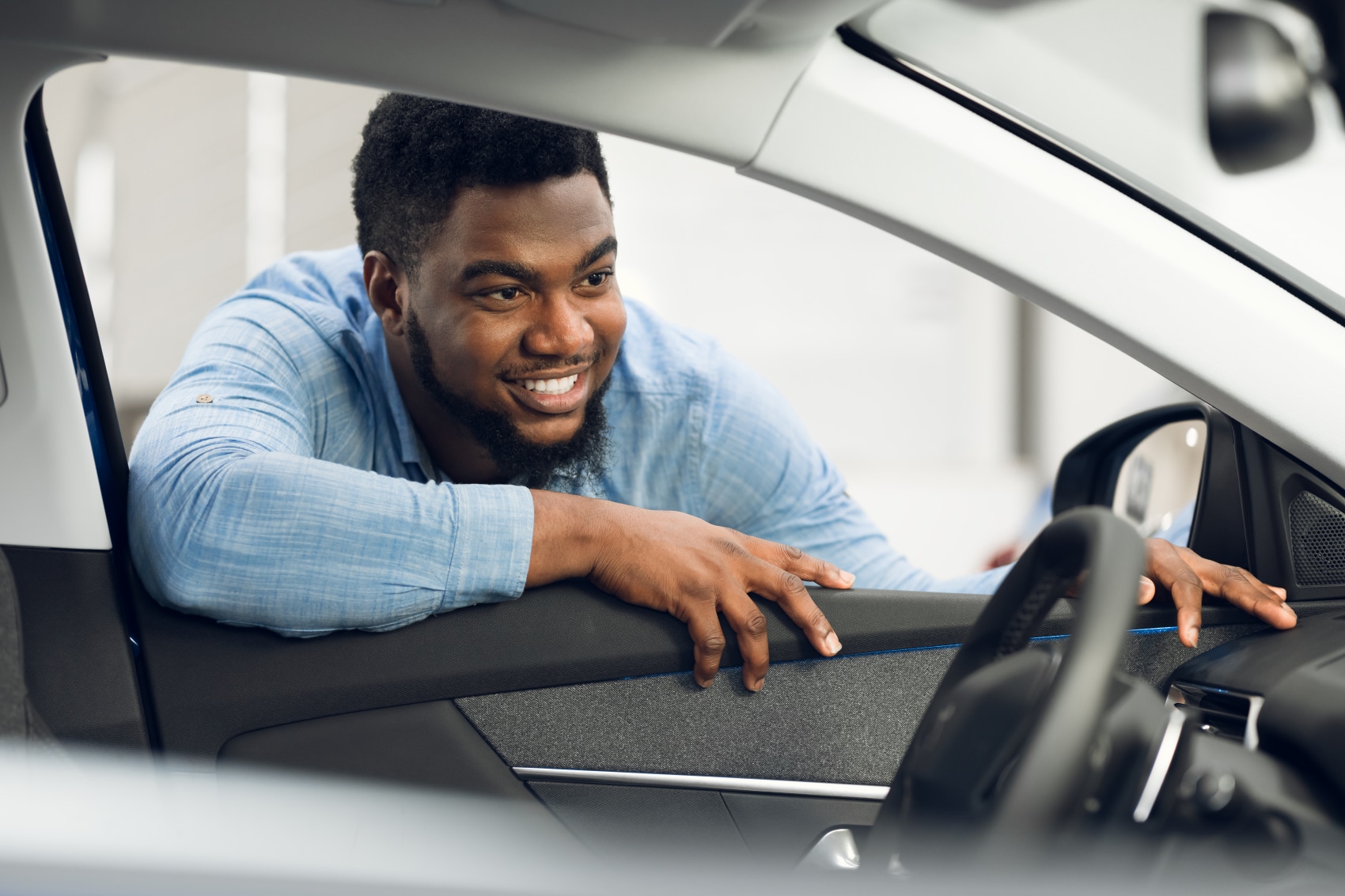 Man Looking at the Interior of a New Volvo