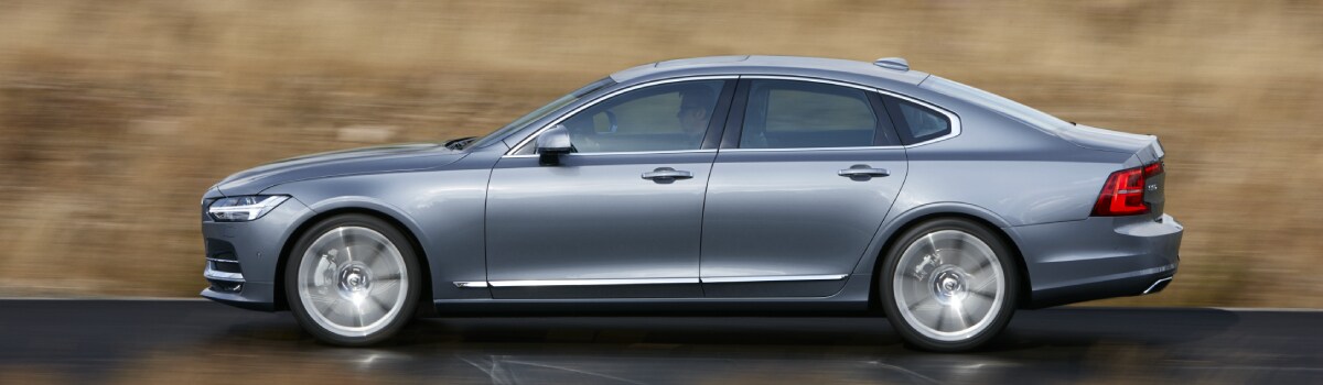 New Volvo S90 driving through a field