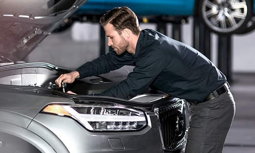 Volvo mechanic working on the engine