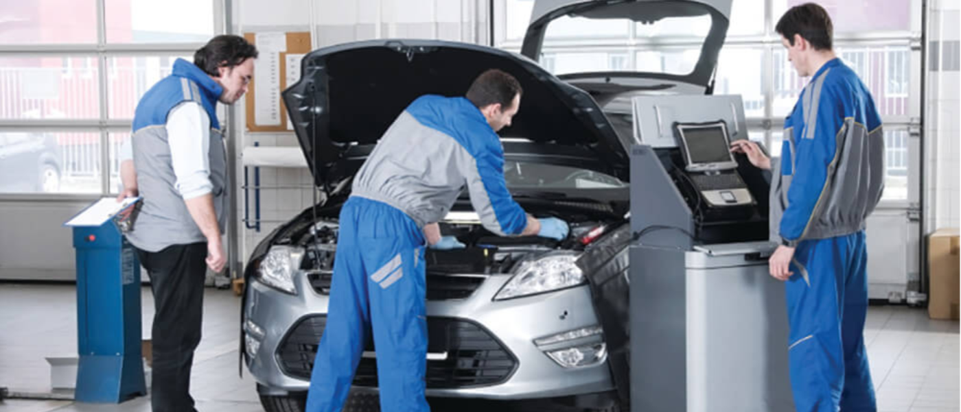 mechanics working on car under the hood
