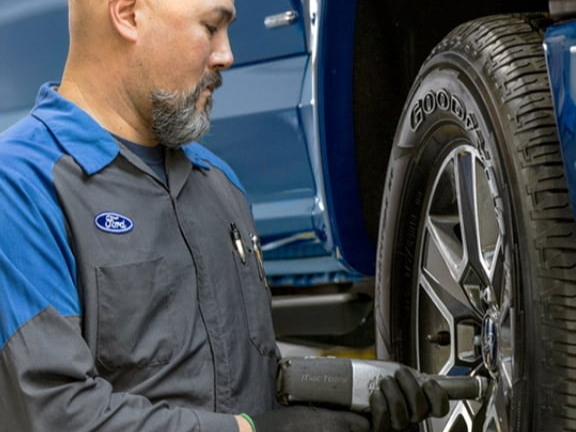 man fixing car tire