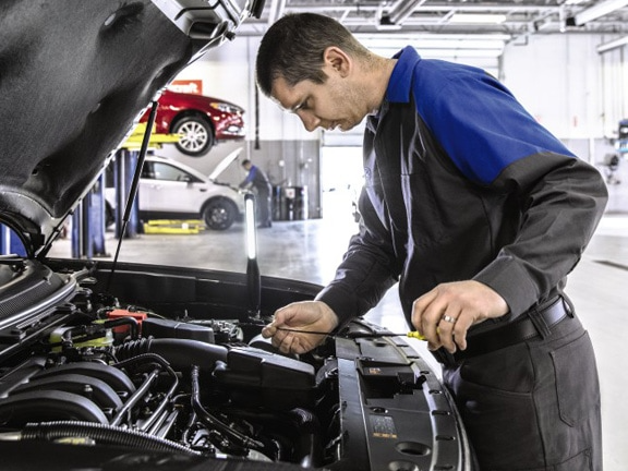 Man looking at car engine