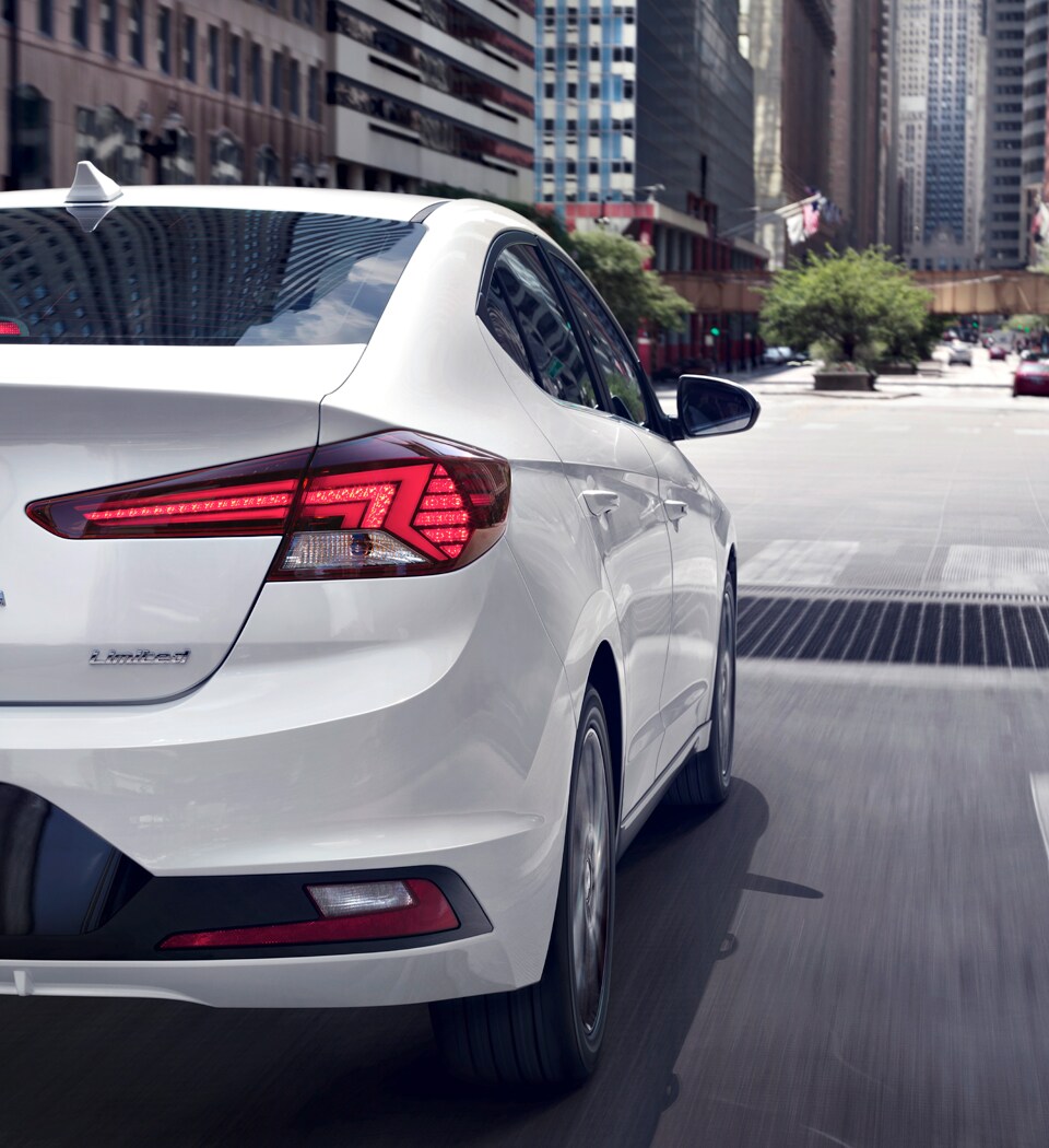What is a Tire Rotation? at West Broad Hyundai | A Photograph From the Back Passaenger Side of the 2021 Hyundai Elantra Limited Driving 