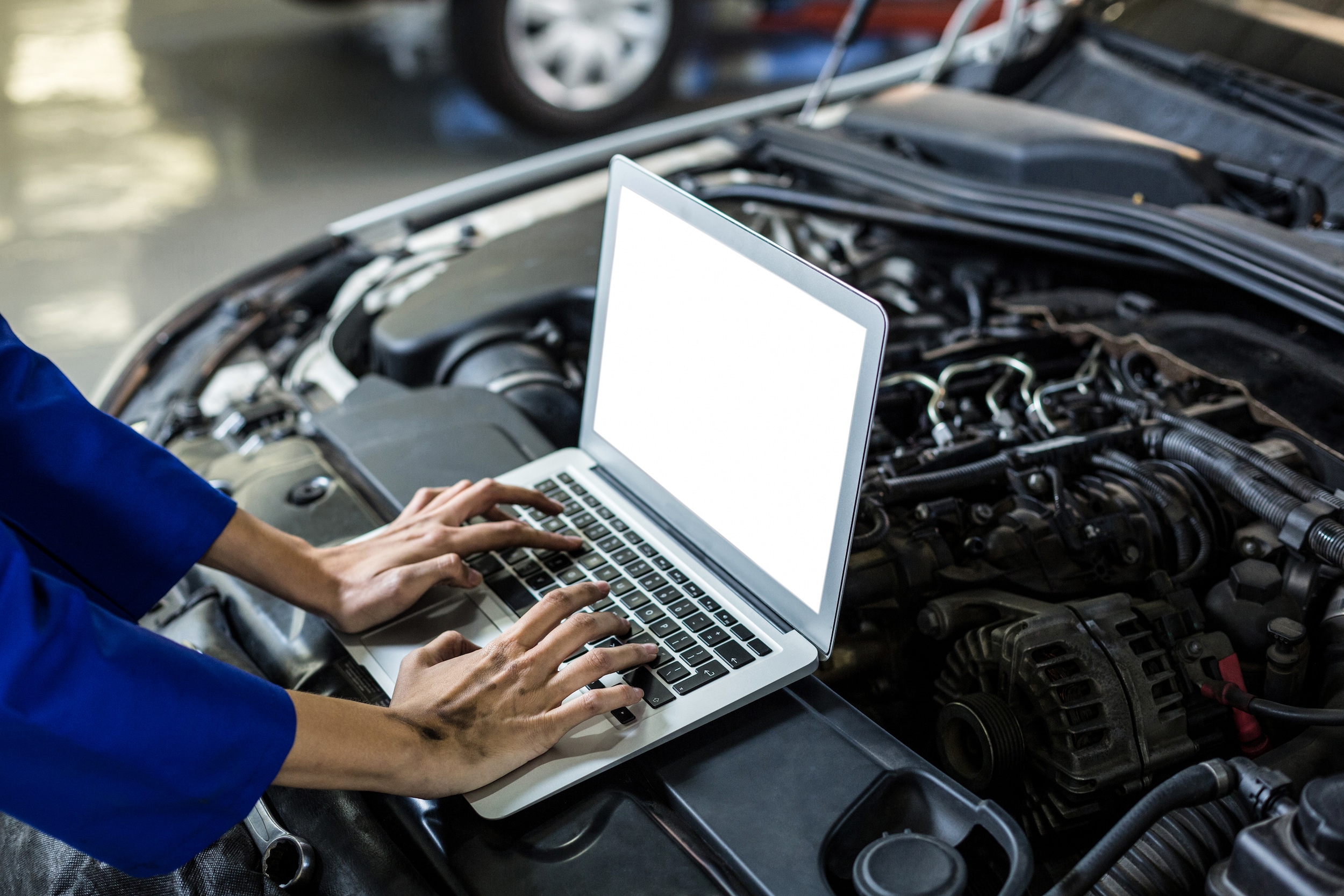 West Broad Hyundai is a Hyundai Dealership near Ashland, VA | Hyndai service technician typing on laptop