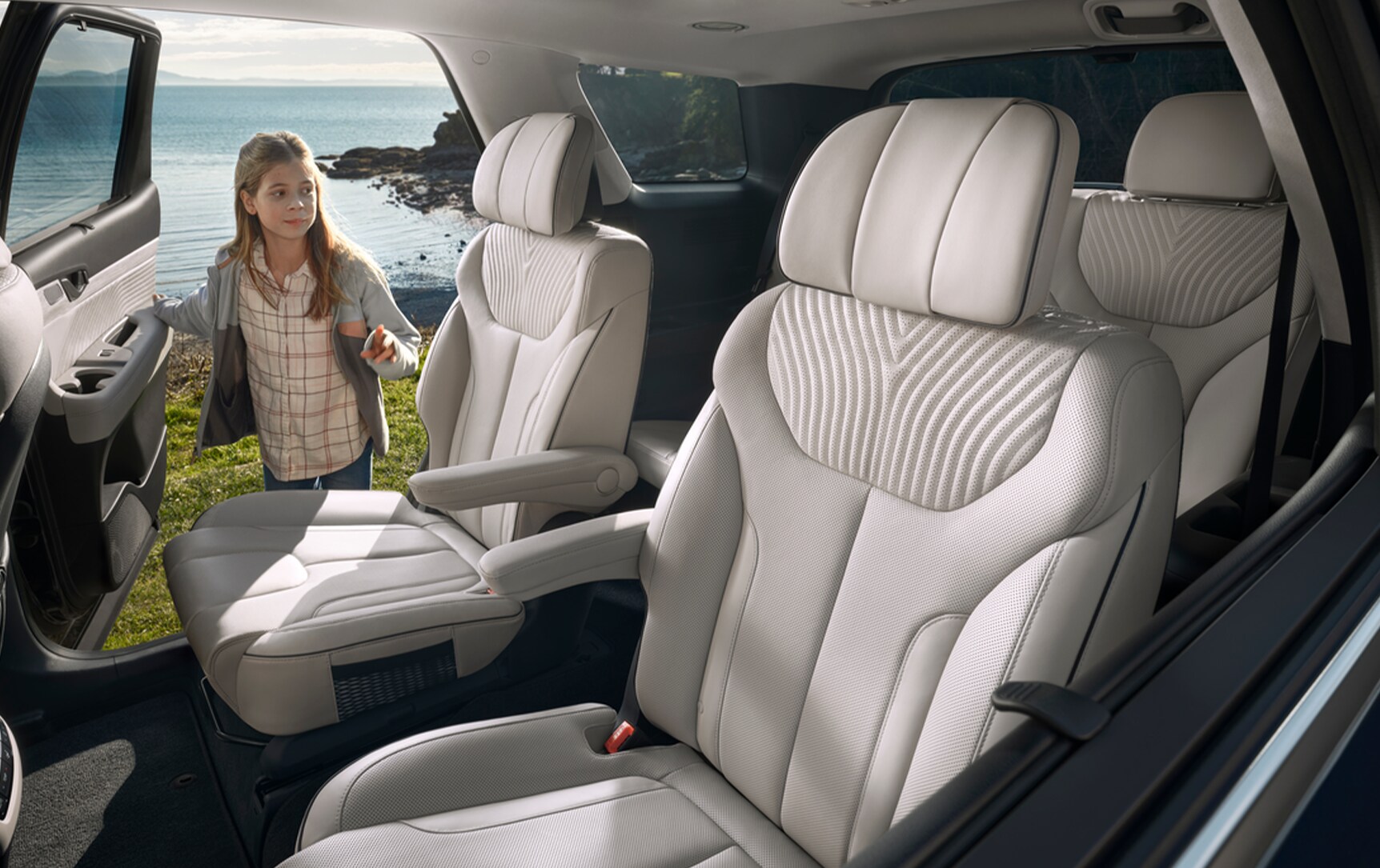 All-New 2023 Hyundai Palisade at West Broad Hyundai | Interior view of the back seats of a Hyundai Palisade while a little girl is opening the car door
