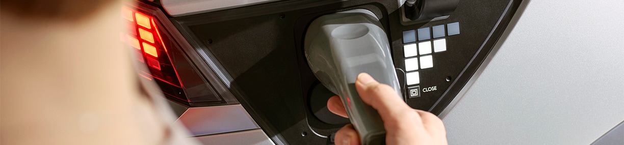 How to prepare your home for your new Electric Vehicle at West Broad Hyundai in Henrico, VA |  Woman connecting car charger to her car 