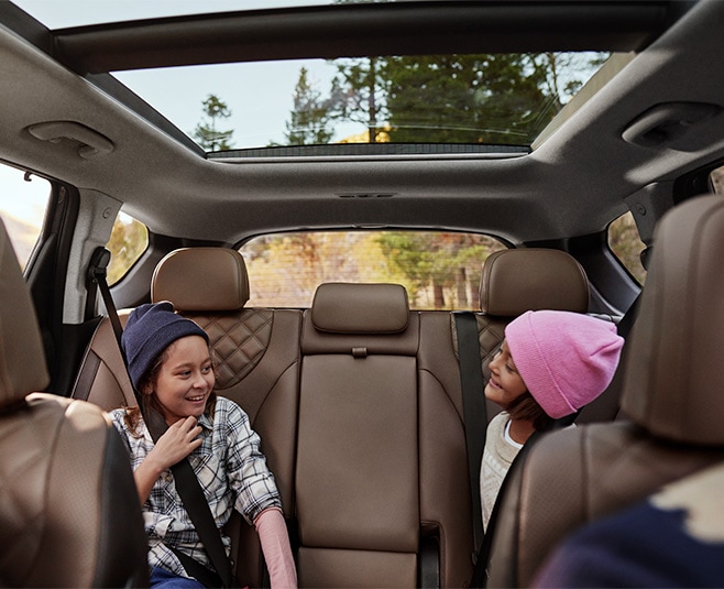 All-New 2022 Santa Fe Plug-in Hybrid at West Broad Hyundai | Two Children Laughing in the Backseat of 2022 Hyundai Santa Fe PHEV