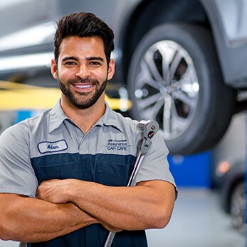 Brake replacement and Safety at West Broad Hyundai | Hyundai mechanic smiles while holding socket wrench