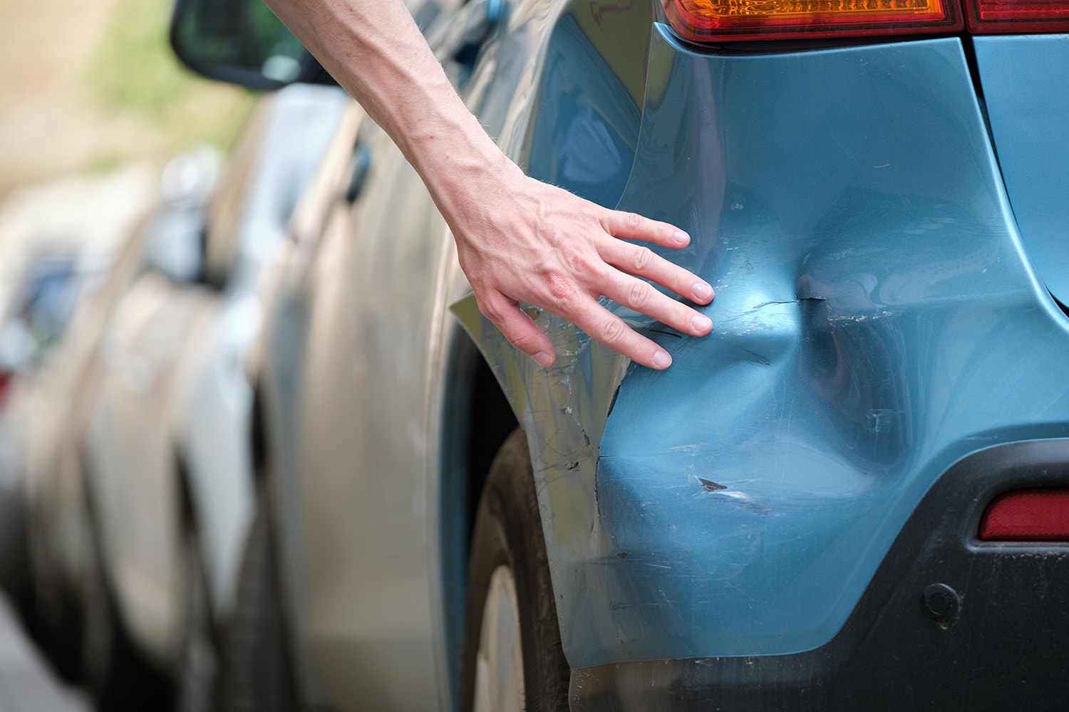 What is Paintless Dent Repair? | West Broad Hyundai | Man pointing to dent on his car that may need more than just paintless dent repair