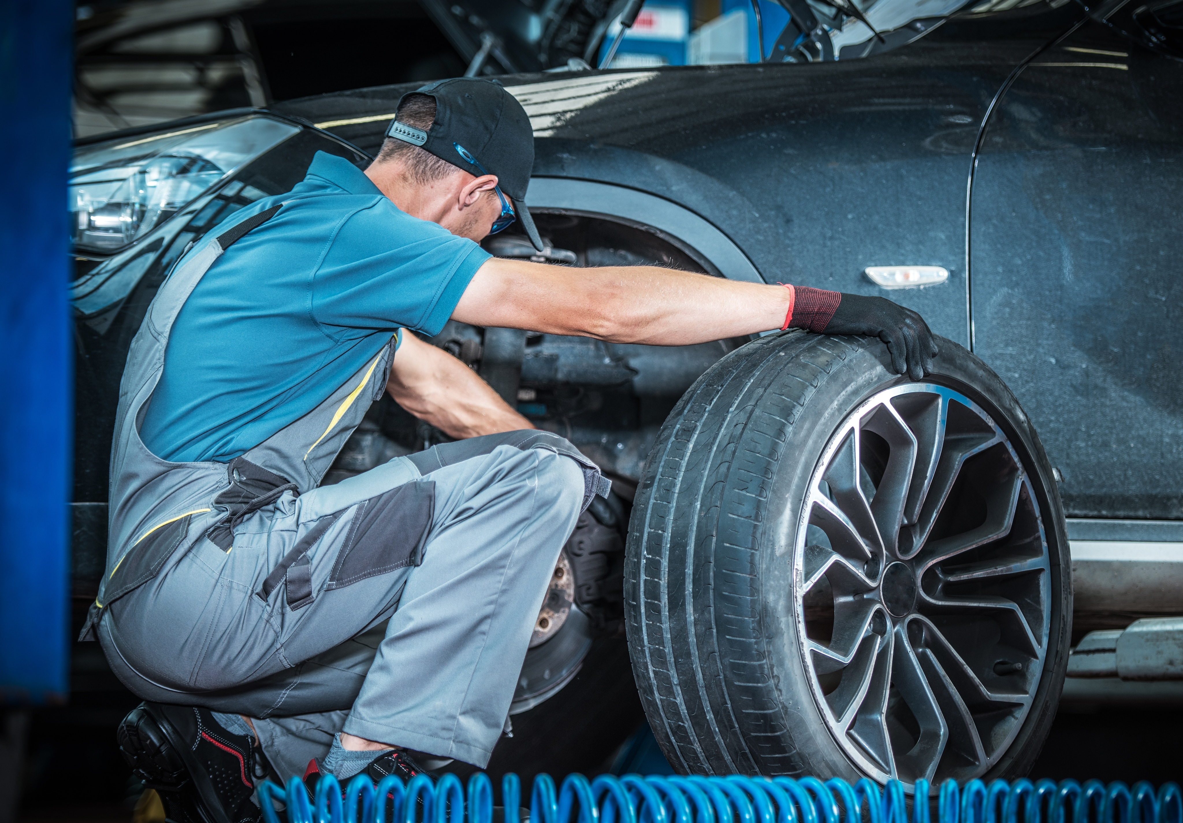 West Broad Kia is a Kia Dealership in Richmond near Charlottesville, VA | Mechanic changing tire on Kia vehicle