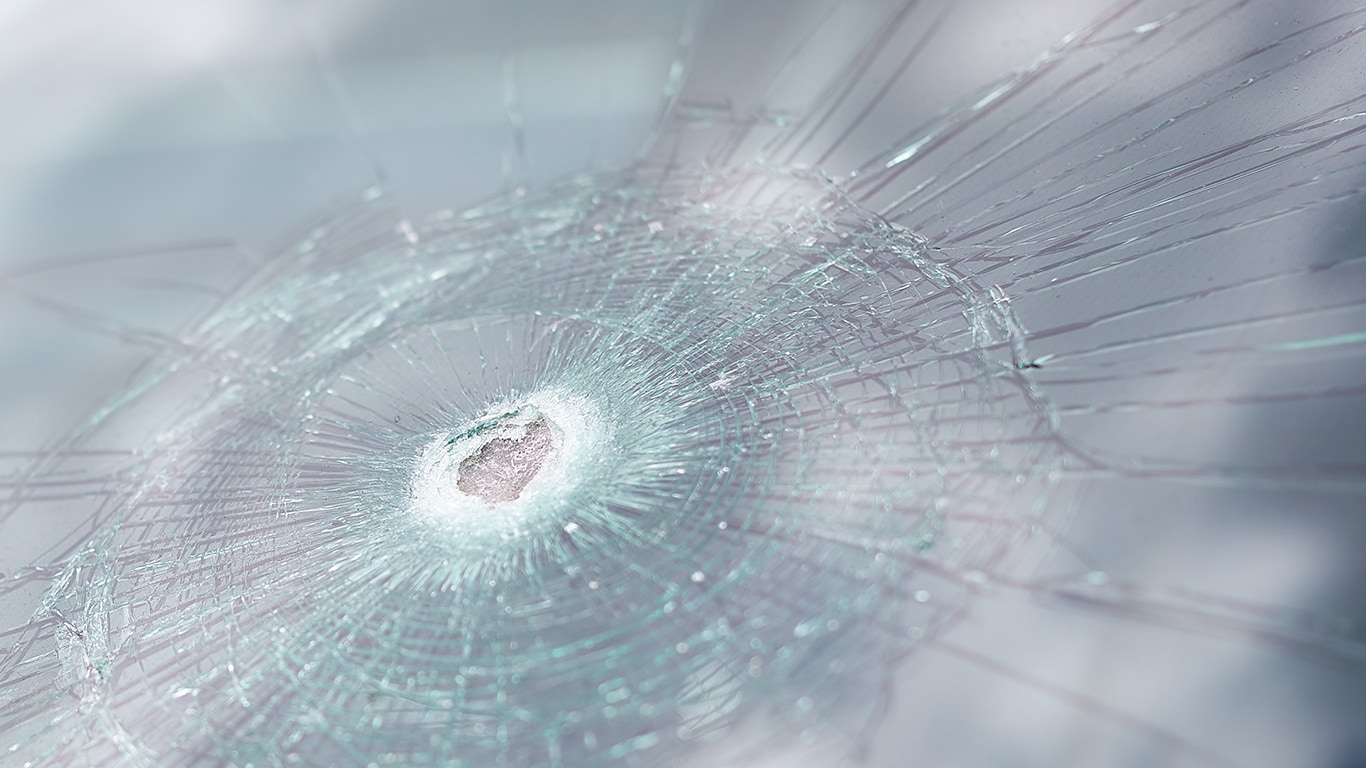 Why You Shouldn’t Drive Around with a Chipped Windshield at West Broad Kia in Richmond, VA | Broken windshield with blue sky reflection 