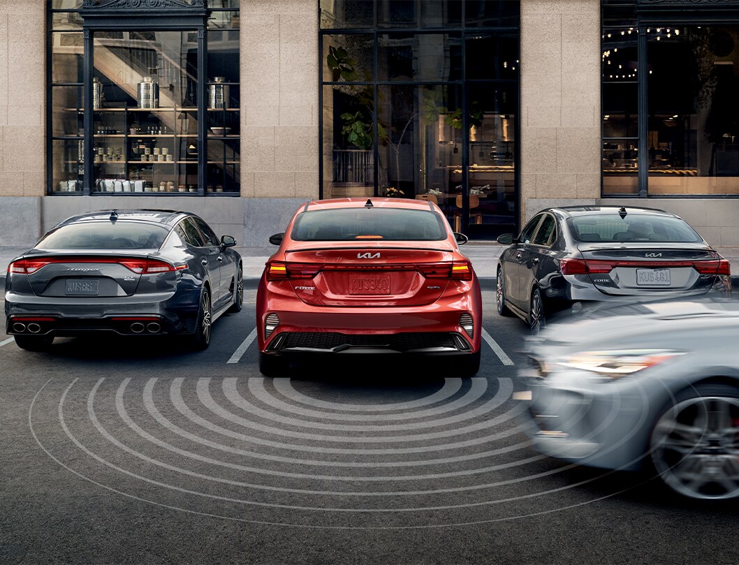 2023 Kia Forte at West Broad Kia in Henrico, VA | Rear 2023 Kia Forte reversing from parking spot with driver attention warning sensor  