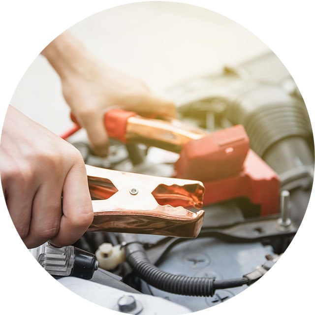How to Jump Start a Car |  West Broad Kia in Richmond, VA | Close Up of Hands Removing Jumper Cables from Car Battery