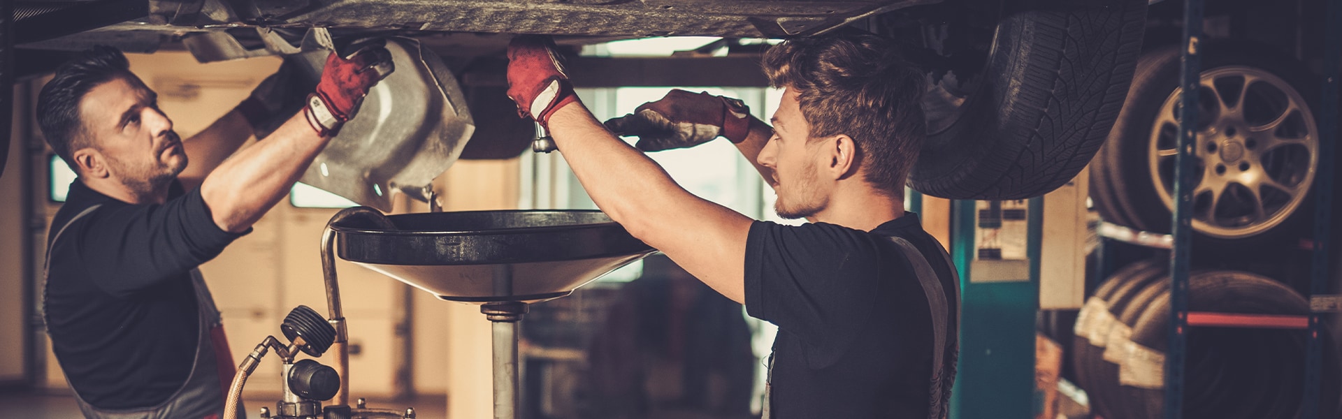 Difference between synthetic oil & conventional oil at West Broad Kia | Two men changing oil