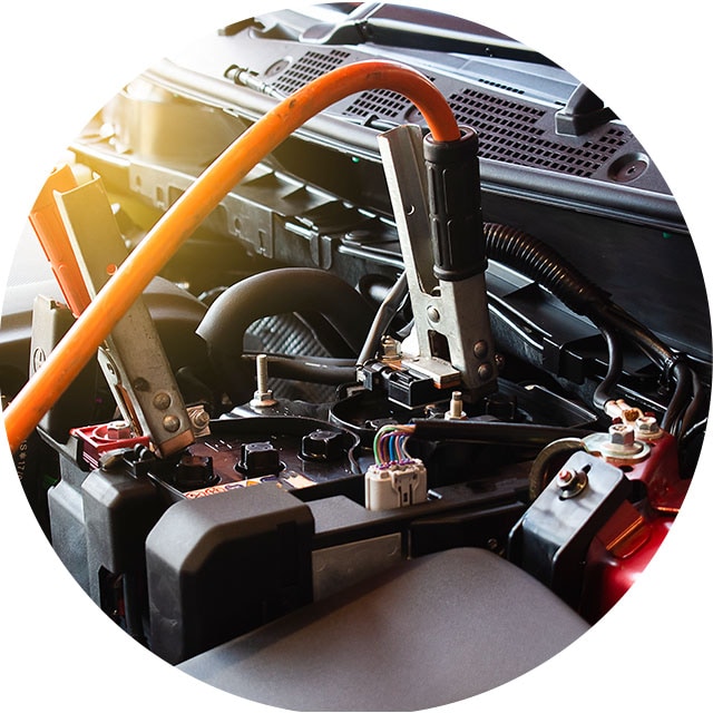 How to Jump Start a Car |  West Broad Kia in Richmond, VA | Close Up of Jumper Cables Attached to a Car Battery 