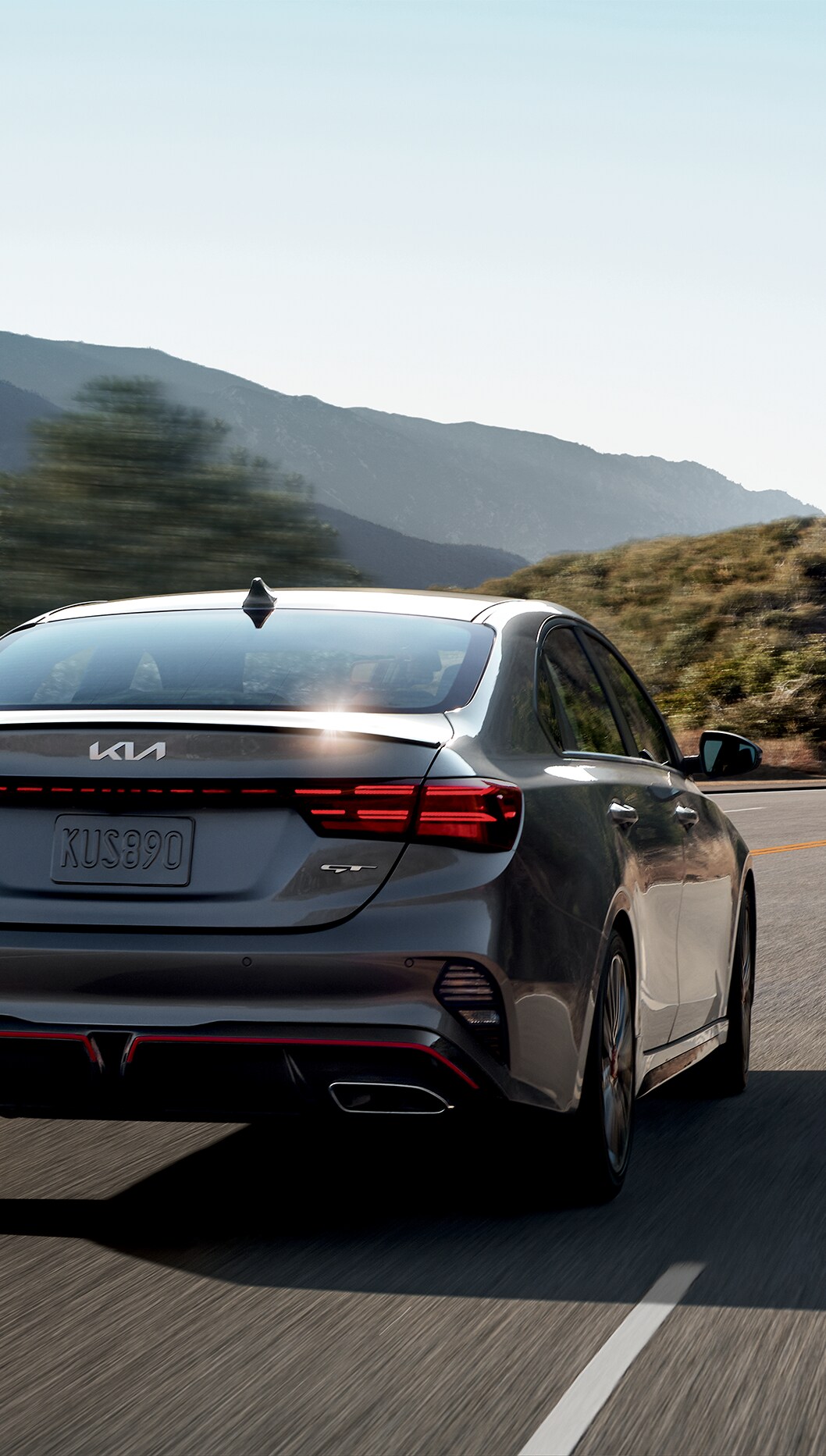 2023 Kia Forte at West Broad Kia in Henrico, VA | Detail look at the rear of a 2023 Kia Forte GT-line driving down a road during the day 