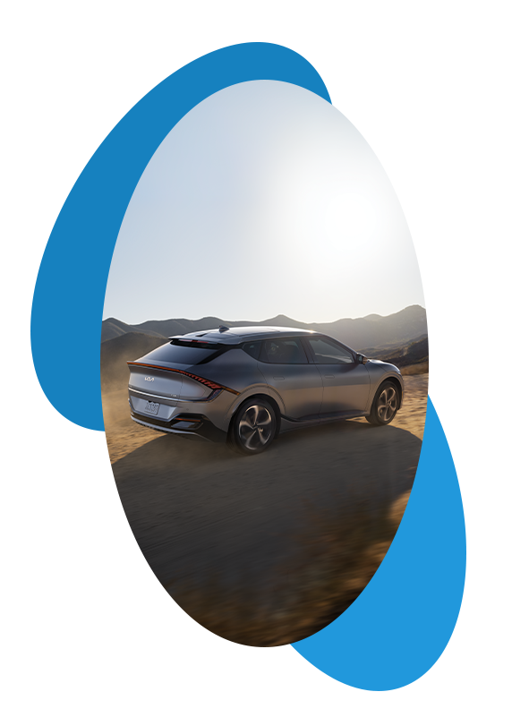 Best Time To Buy At West Broad Kia in Henrico, VA |  Rear profile of a grey 2023 Kia EV6 driving on a dirt road 
