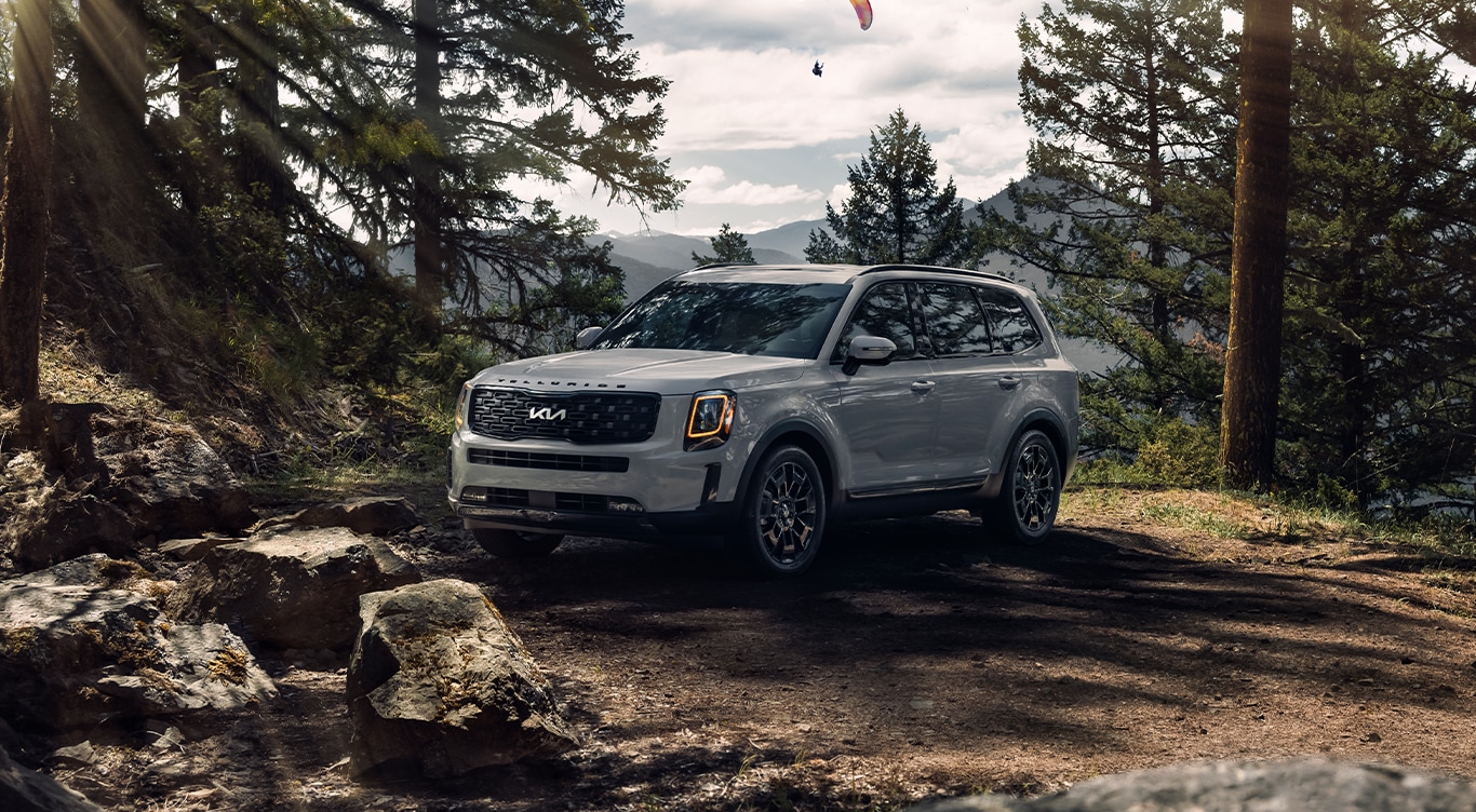 Android Auto vs. Apple CarPlay at West Broad Kia in Henrico, VA | Grey 2023 Kia Telluride parked in the middle of the woods