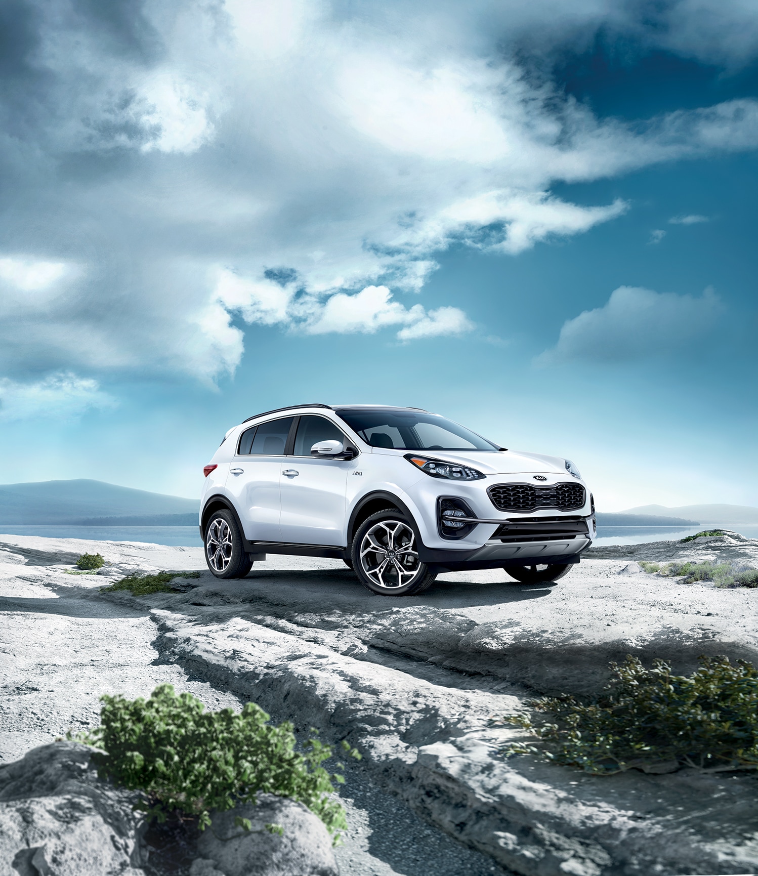 West Broad Kia is a Kia Dealership in Richmond near Short Pump, VA | 2020 Kia Sportage parked in front of mountains