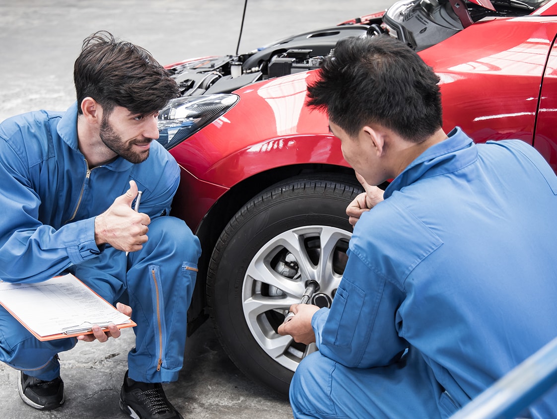 What is Paintless Dent Repair? | West Broad Kia | Two mechanics inspecting red car and giving a thumbs up