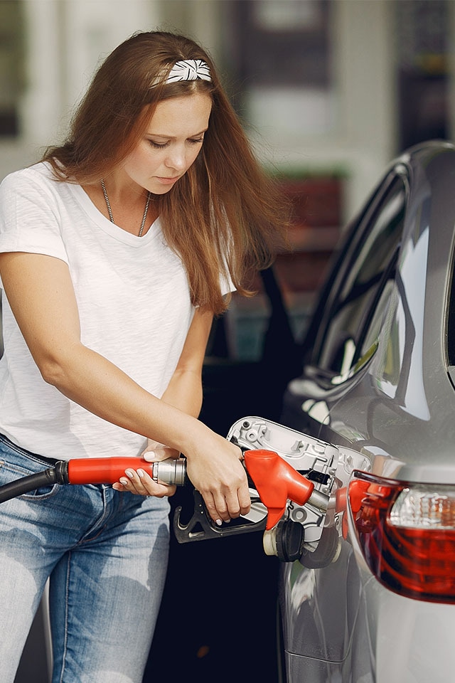 What Type of Gas is Best for My Car? | West Broad Kia in Richmond | Woman Pumping Gas into Silver Car
