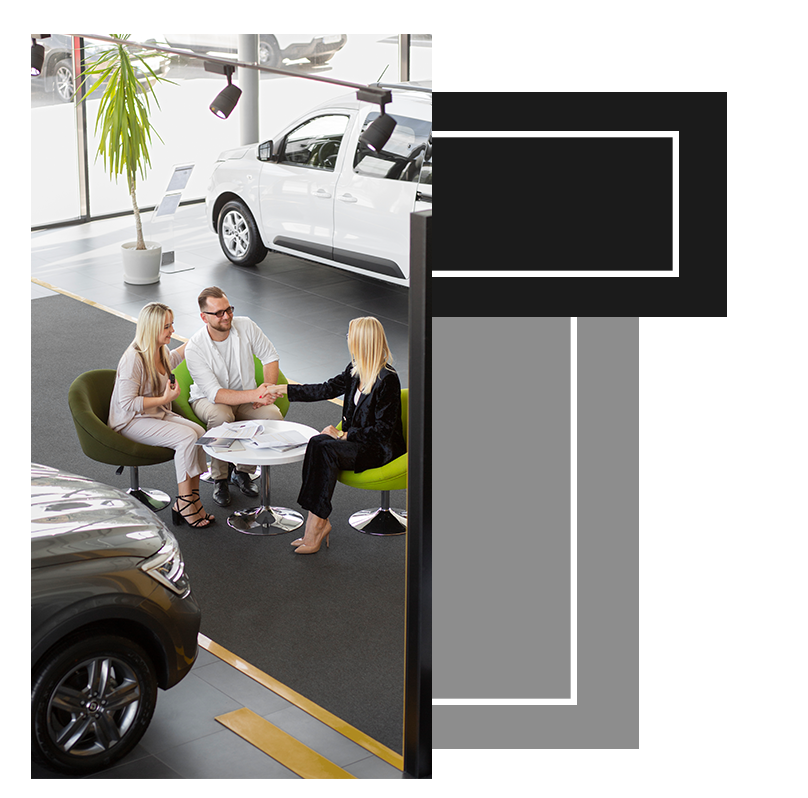Things to Bring with you to Purchase a Car at West Broad Kia in Henrico, VA | Man in white shirt shaking hands with sales person inside of a dealership