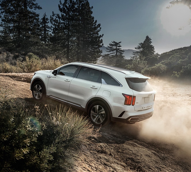 The All-New 2022 Kia Sorento Plug-In Hybrid at West Broad Kia in Richmond | White 2022 Kia Sorento Plug-In Hybrid Driving Uphill on Dusty Dirt Road