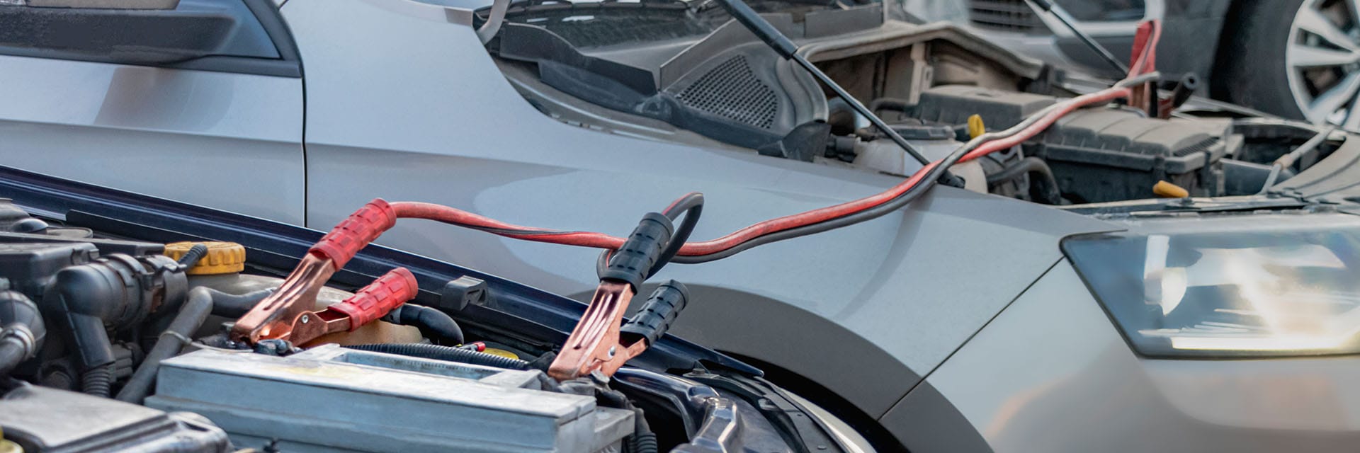 How to Jump Start a Car |  West Broad Kia in Richmond, VA | Close up of Jumper Cables Connecting One Car Battery to Another