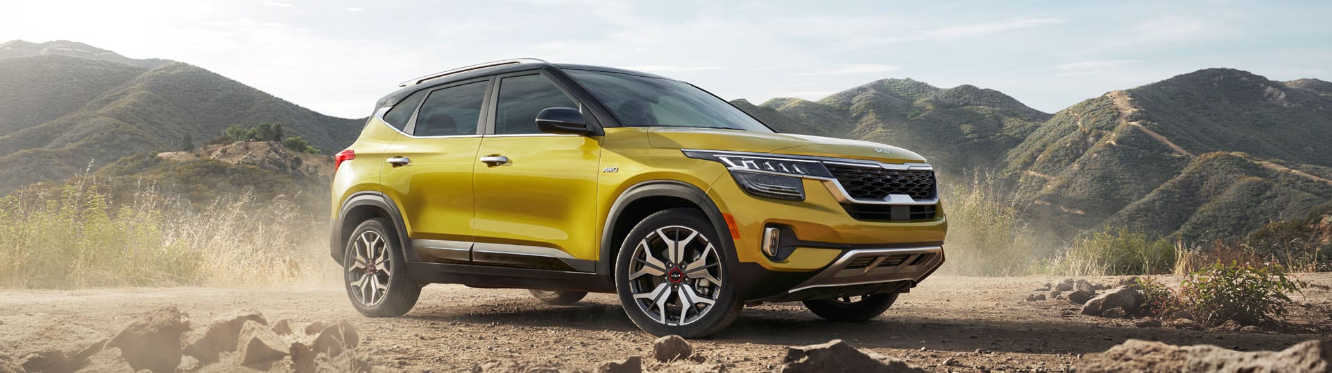 Tips for spring cleaning your car at West Broad Kia in Richmond, VA | Yellow Kia Seltos Parked on Rocky Road