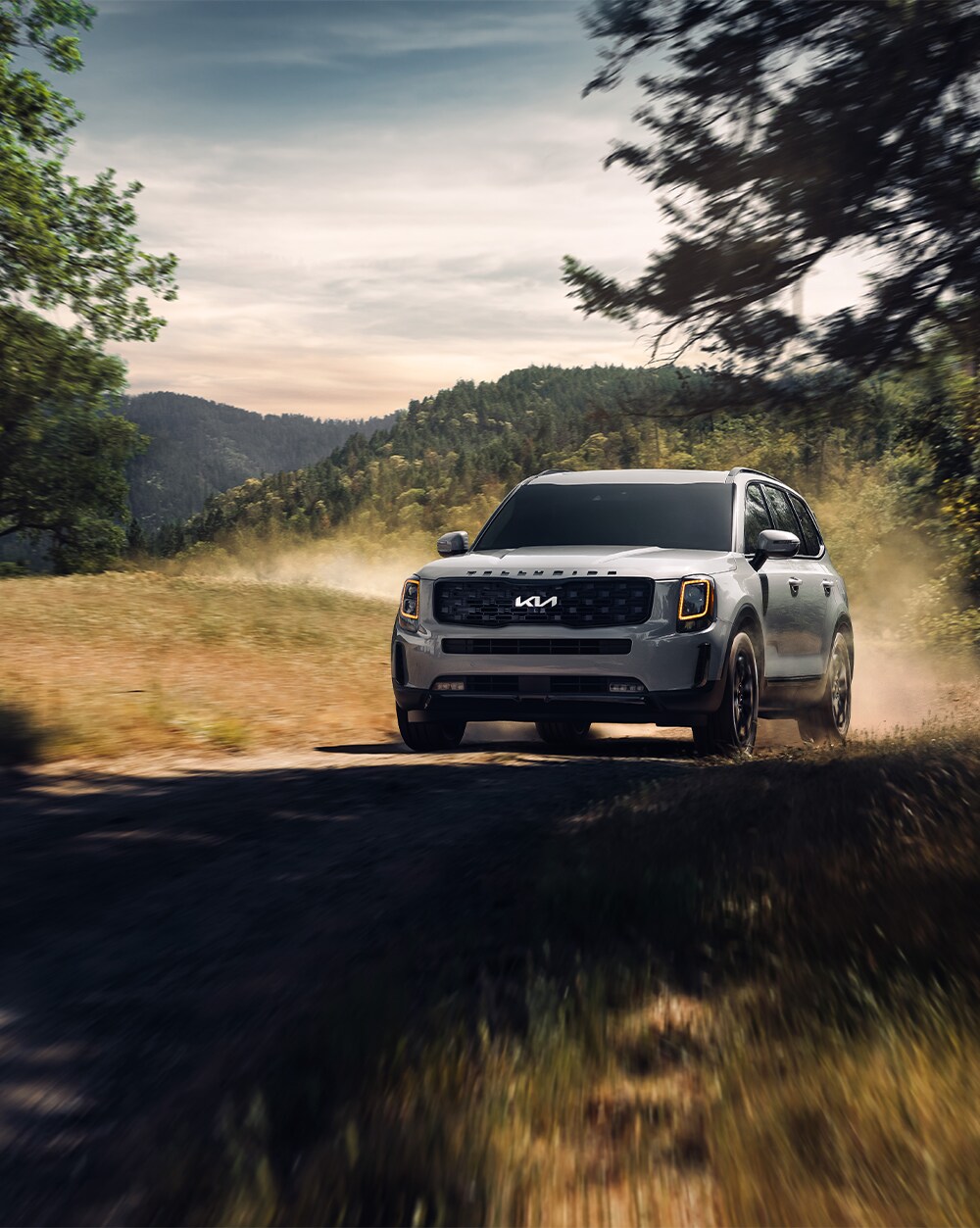 2023 Kia Telluride at West Broad Kia in Henrico, VA | Silver 2023 Kia Telluride driving off road on a sunny day