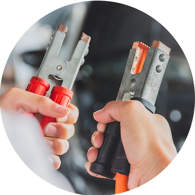 How to Jump Start a Car |  West Broad Kia in Richmond, VA | Hands Holding Red Jumper Cable in Left Hand and Black Jumper Cable in Right Hand