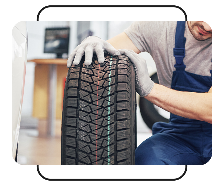 Tire Pressure Information at West Broad Kia in Henrico, VA | Mechanic inspecting car wheel