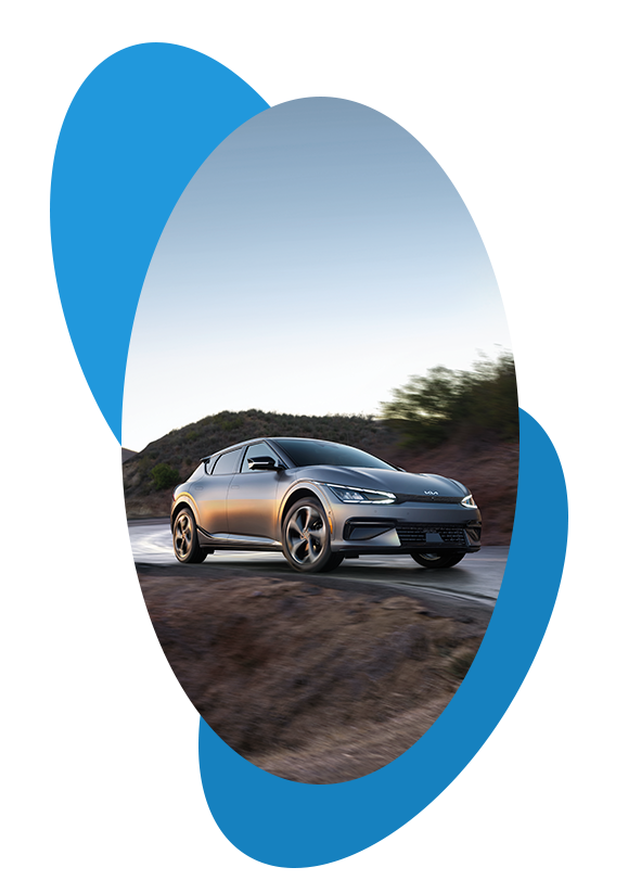 Best Time To Buy At West Broad Kia in Henrico, VA |  Front profile of a grey 2023 Kia EV6 driving on the road 