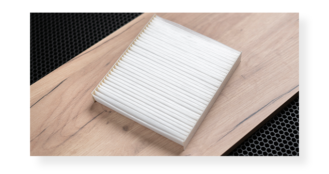 Everything You Need to Know About Cabin Air Filters | West Broad Kia | Brand new cabin air filter laying on top of a wooden panel 