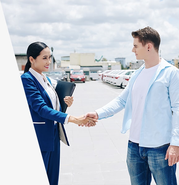 West Broad Kia is a Kia Dealership in Richmond near Bon Air, VA | Customer & Sales Advisor Shaking Hands in Dealership Lot