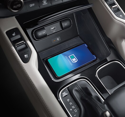 Compare the 2021 Kia Telluride vs. the 2021 Honda Pilot at West Broad Kia | Center console charging phone