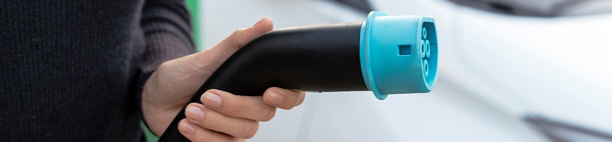 How to prepare your home for your new Electric Vehicle at West Broad Kia in Henrico, VA | Close up of car charging cable with blue tip