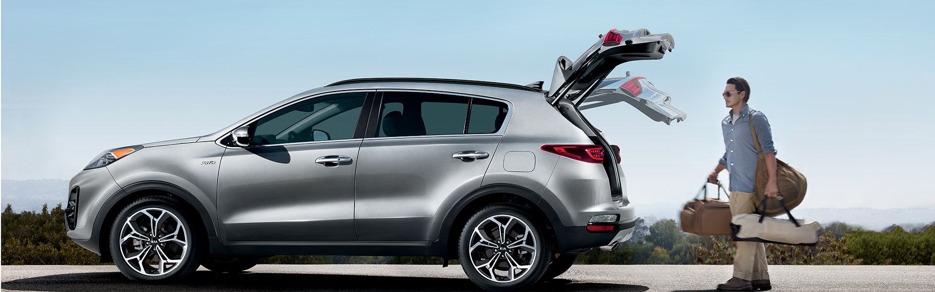 Performance features of the 2022 Telluride at West Broad Kia of Richmond | Man Loading Luggage into the Spacious Trunk