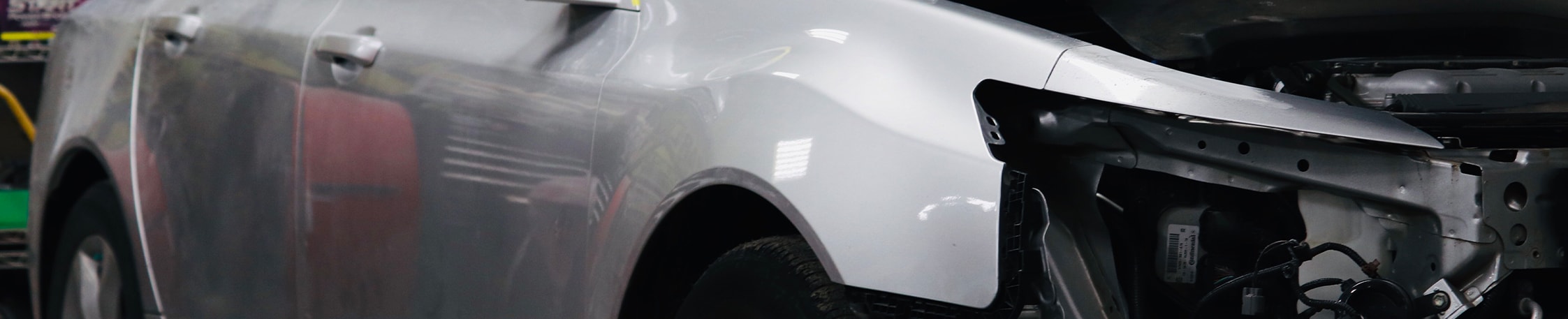 What is Paintless Dent Repair? | West Broad VW | Silver car in the body shop with headlights missing