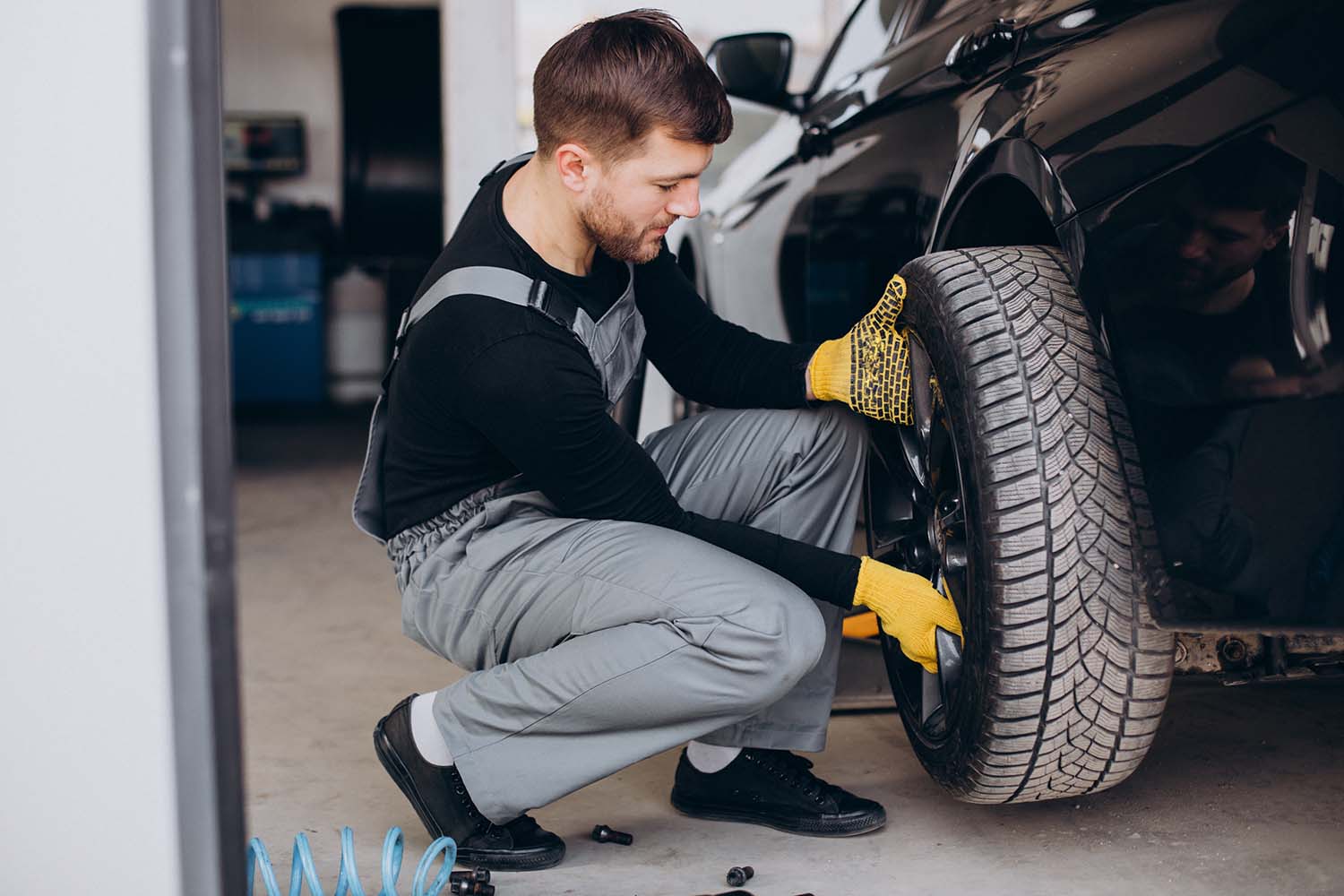 Tips for spring cleaning your car at West Broad Volkswagen in Richmond, VA | Mechanic replacing tires on vehicle before spring