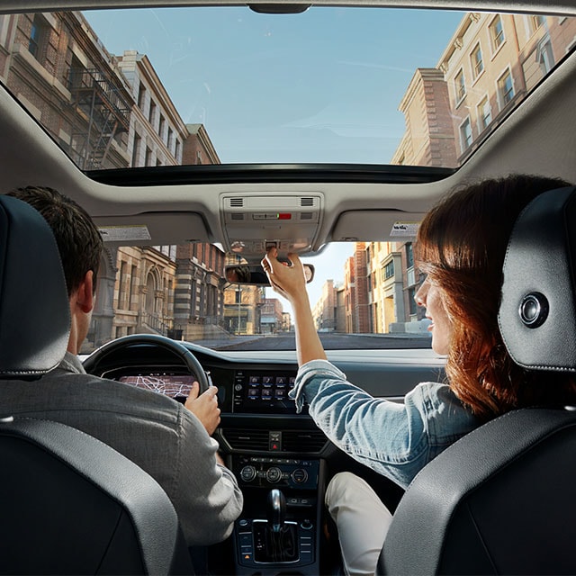 Accessories that help keep your Volkswagen protected at West Broad Volkswagen in Richmond, VA | Interior SHot from Backseat of Volkswagen Jetta with People sitting in Driver and Passenger Seats