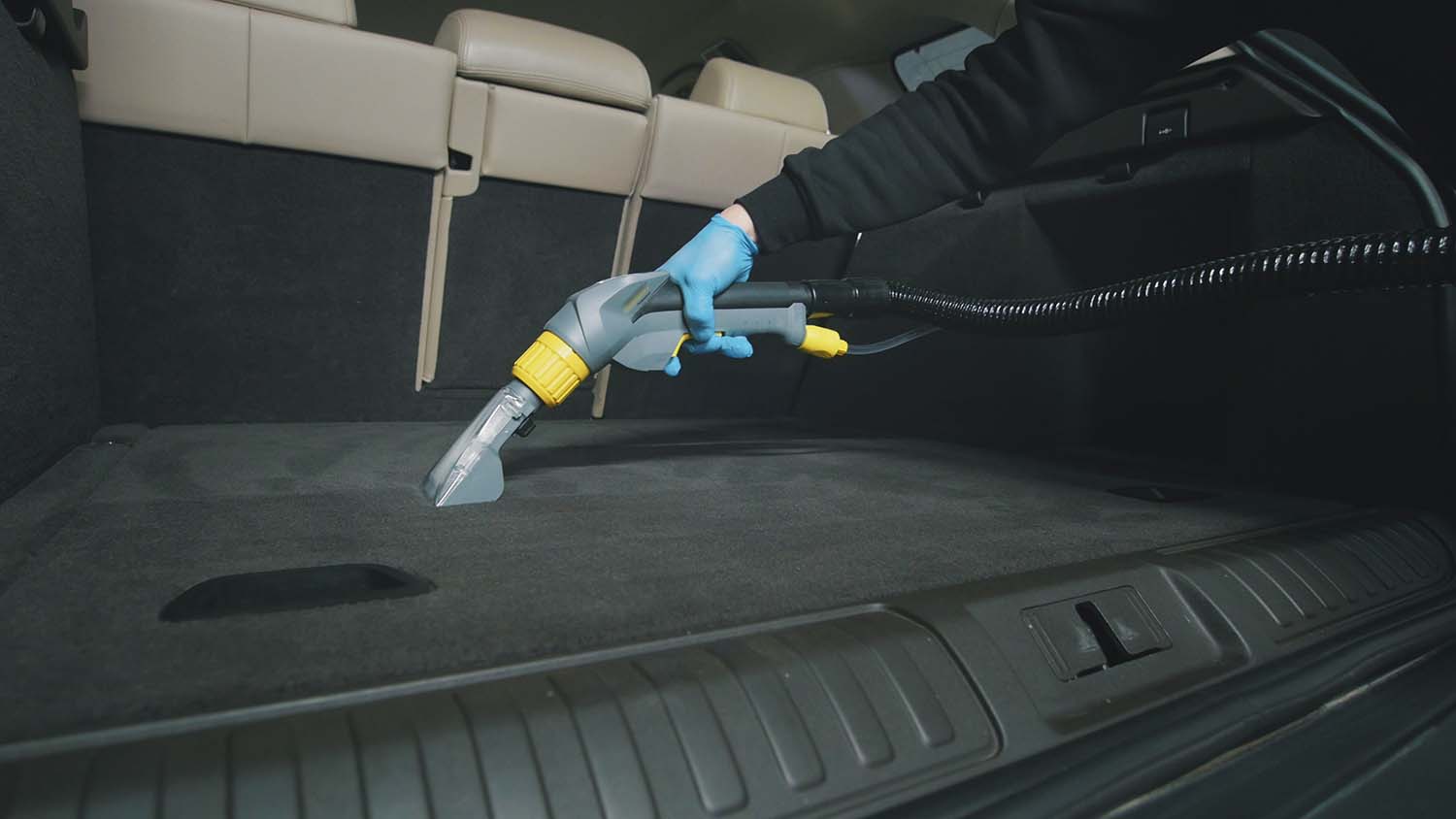 Tips for spring cleaning your car at West Broad Volkswagen in Richmond, VA | Volkswagen service technician detailing and vacuuming car